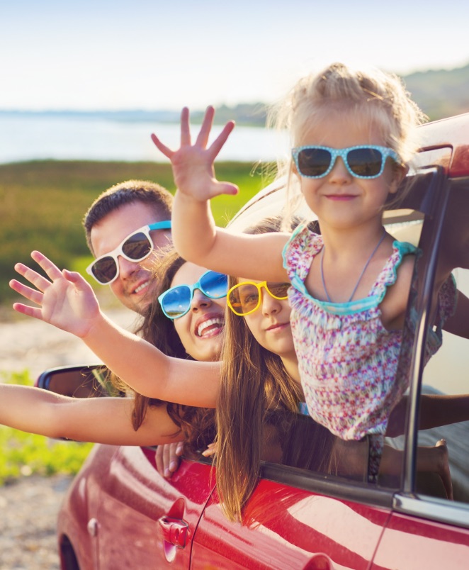 Family waving from car