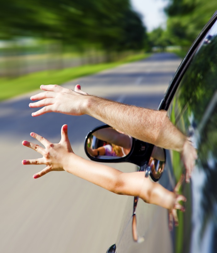 Hands waving out car window