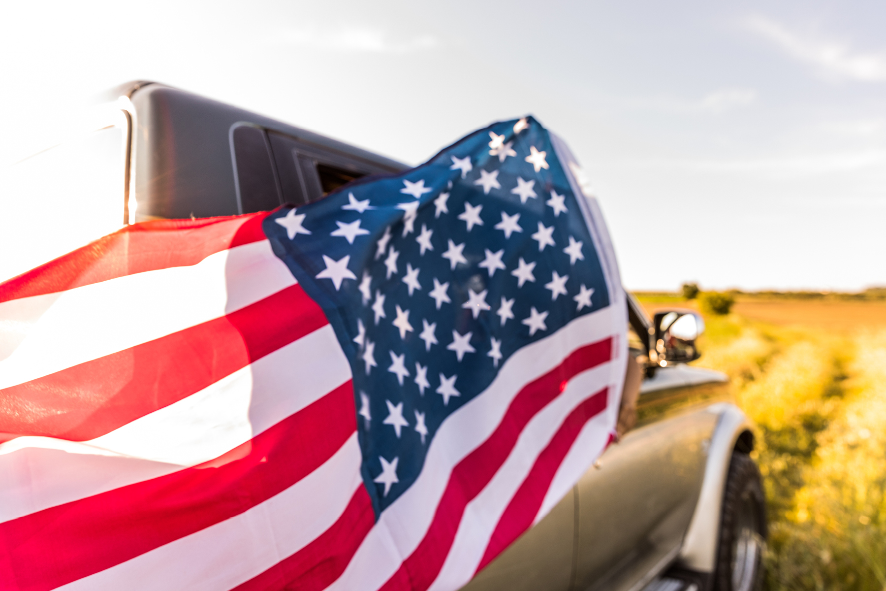 American flag flying on a truck